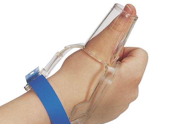 A toddler's hand with a clear thumb guard strapped on to stop thumb sucking.