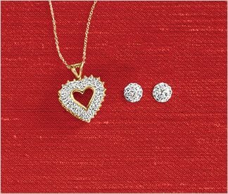 Diamond and gold heart with gold chain necklace and diamond stud earrings on a red background.