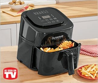 As seen on TV, a black Nuwave power air fryer with French fries on a kitchen counter.
