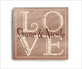 Personalized LOVE wall canvas in beige and brown with a couple's first names overprinted.