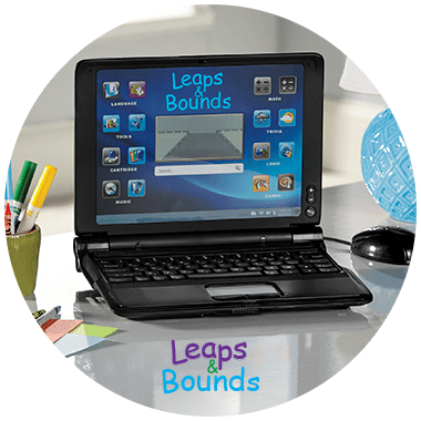 A Kid's Leaps & Bounds brand learning laptop on a desk with a jar of markers nearby.