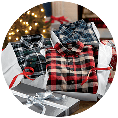 A variety of three men's plaid shirts folded in gift boxes.