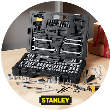 A Stanley brand set of tools in an opened black carrying case, with some tools spread on the work bench.