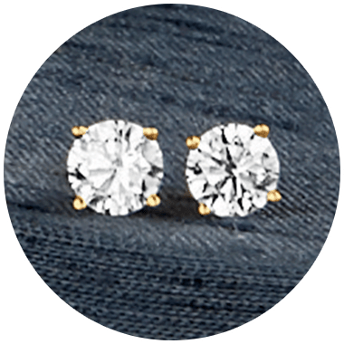 Women's diamond cut stud earring set with gold prongs.
