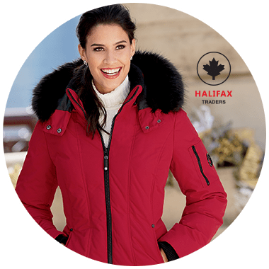 Smiling woman wearing a Halifax Traders brand red zippered winter coat with full black faux fur hood trim.